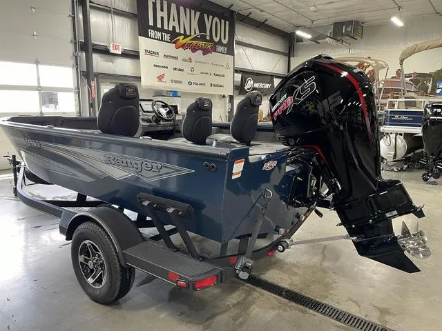 Slide: The Image of 2025 Ranger VS1782SC Angler boat with powerful outboard motor in showroom setting. - 9