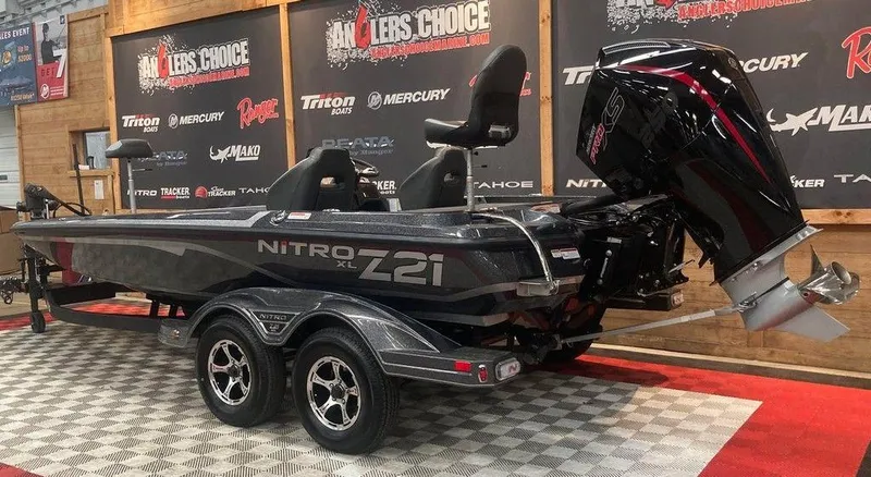 Slide: The Image of 2025 Nitro Z21 XL boat with powerful outboard motor on display in showroom. - 3