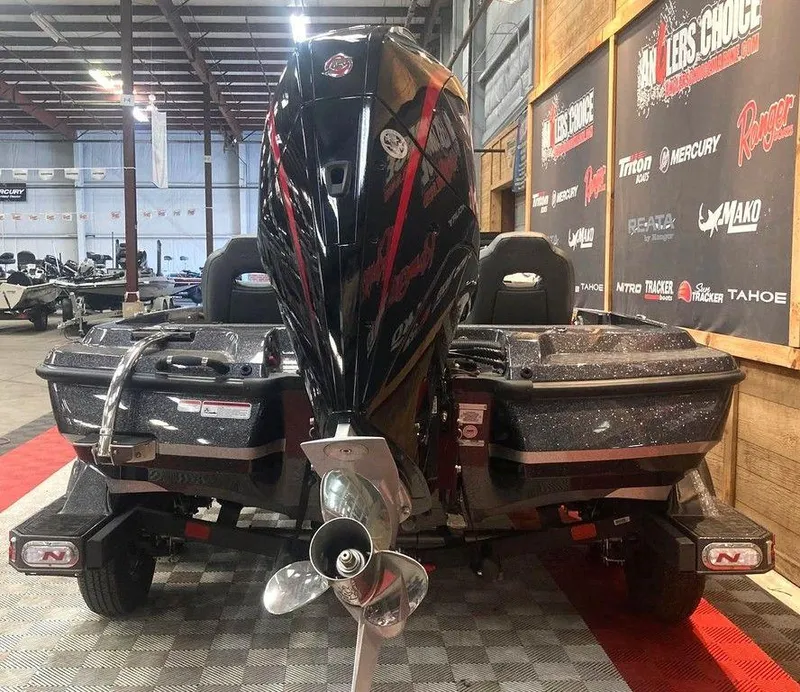 Slide: The Image of 2025 Nitro Z21 XL boat in showroom, rear view with powerful engine and propeller. - 4