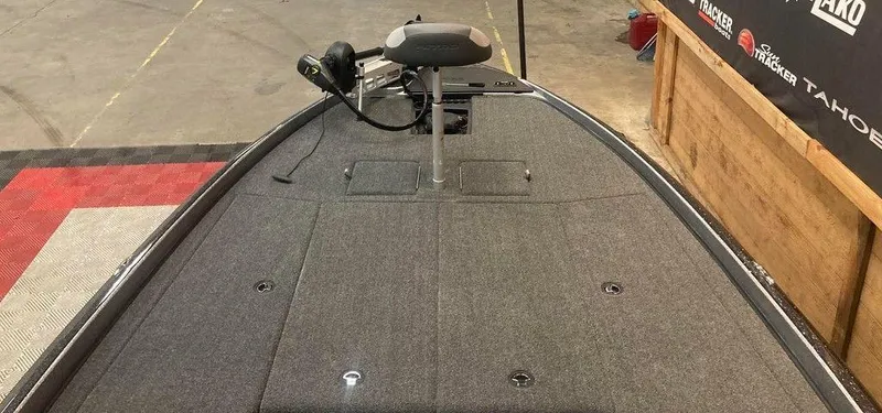 Slide: The Image of 2025 Nitro Z21 XL boat deck with trolling motor in showroom setting. - 8