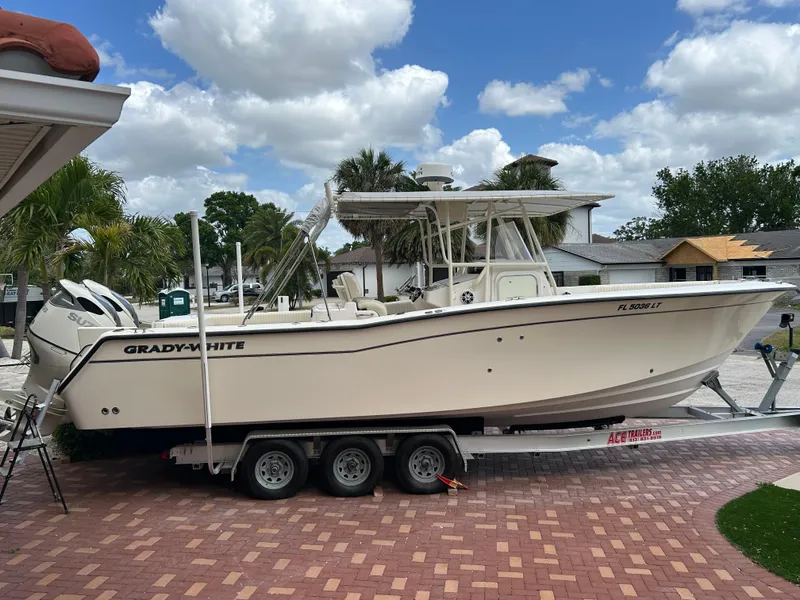 The Image of 2002 Grady-White 306 Bimini boat on trailer, parked on brick driveway. - 0