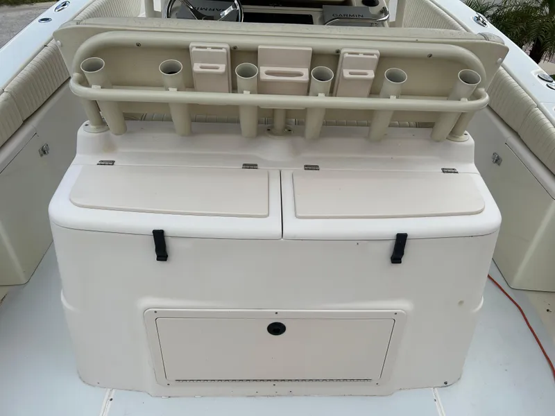 Slide: The Image of 2002 Grady-White 306 Bimini boat with rod holders and storage compartments. - 19