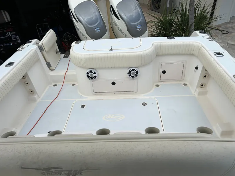 Slide: The Image of 2002 Grady-White 306 Bimini boat deck with seating and storage compartments. - 22