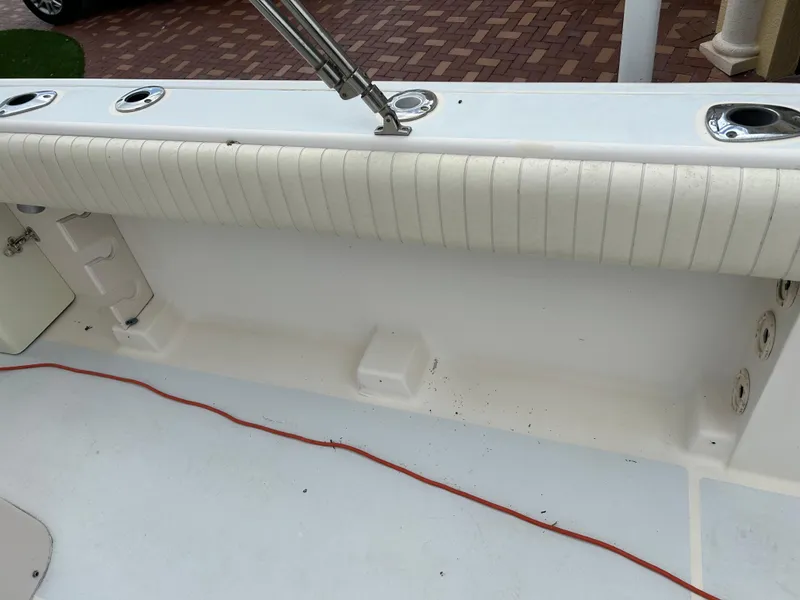 Slide: The Image of 2002 Grady-White 306 Bimini boat interior with rod holders and cushioned seating. - 29