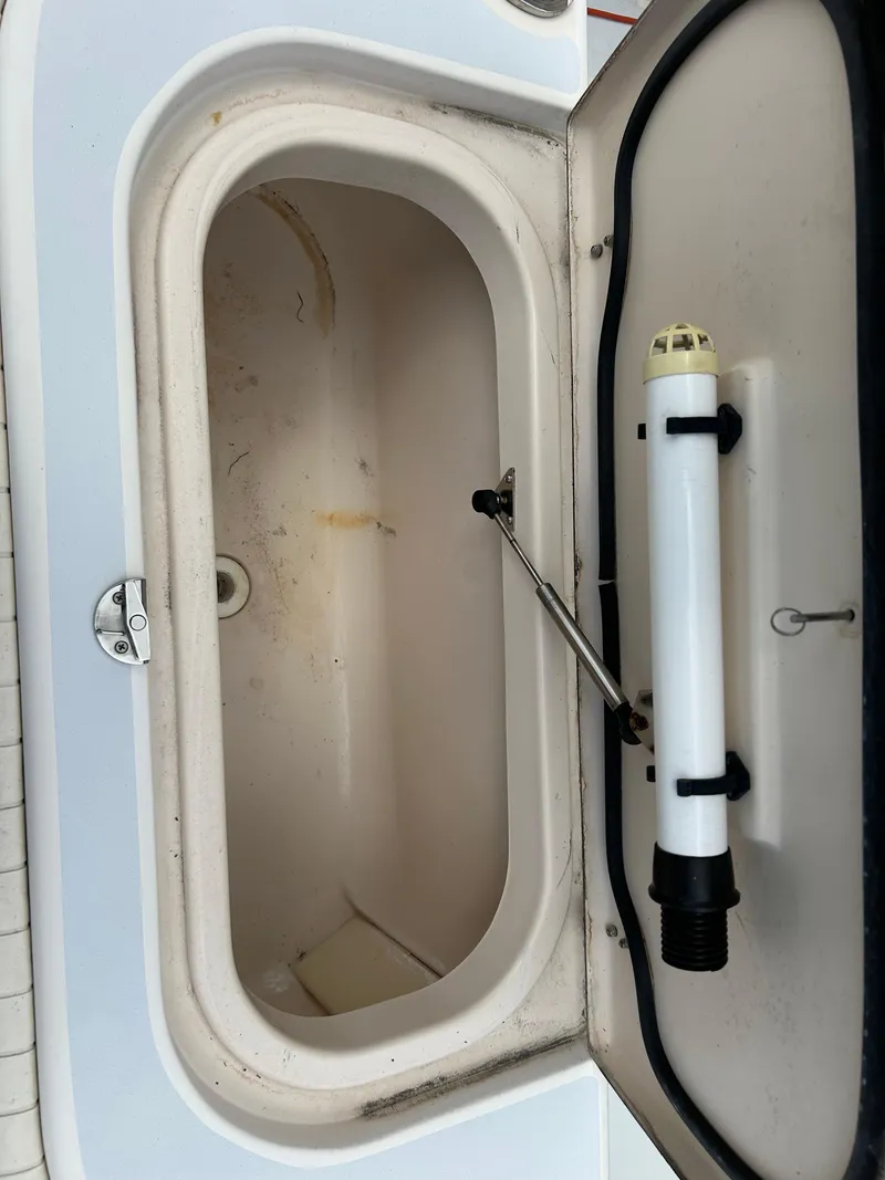 Slide: The Image of Open storage compartment on 2002 Grady-White 306 Bimini boat. - 32