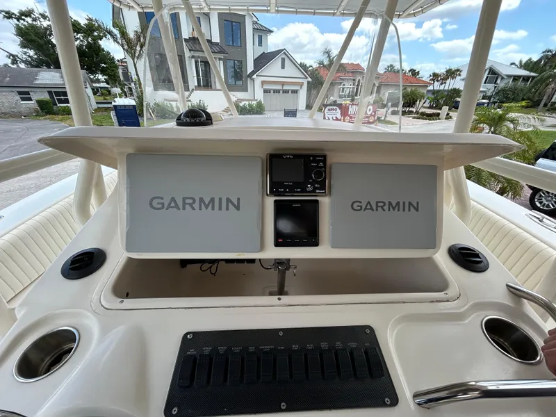 Slide: The Image of 2002 Grady-White 306 Bimini boat dashboard with Garmin navigation systems. - 6