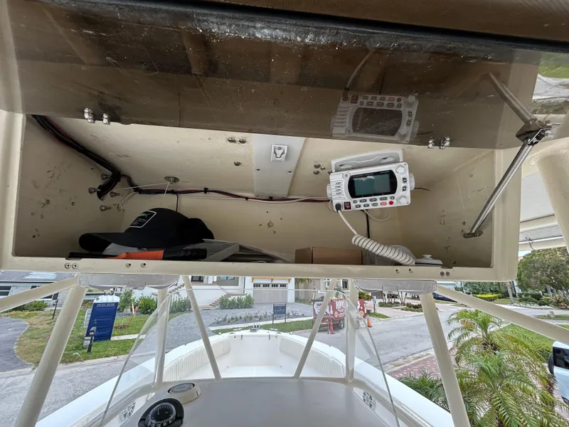 Slide: The Image of 2002 Grady-White 306 Bimini boat console with storage and radio equipment. - 9