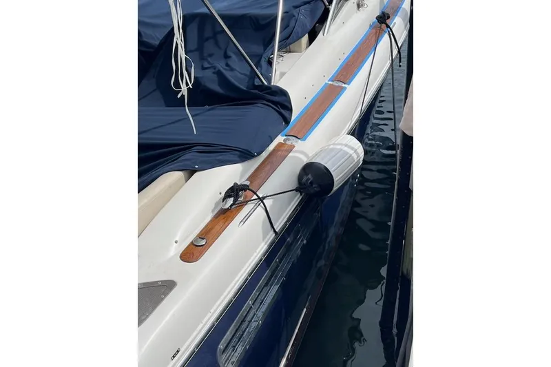 Slide: The Image of 2007 Chris-Craft Corsair 36 boat with fender, docked and covered. - 10