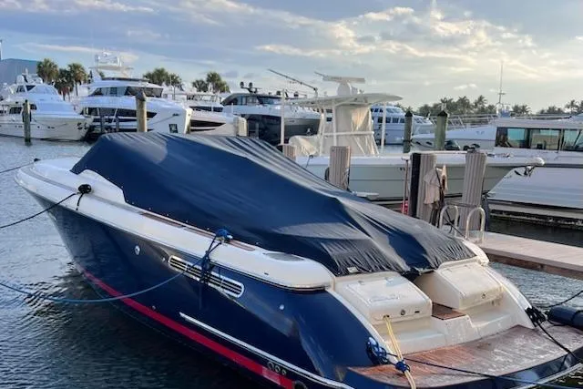 Slide: The Image of 2007 Chris-Craft Corsair 36 boat docked with cover, surrounded by yachts. - 2