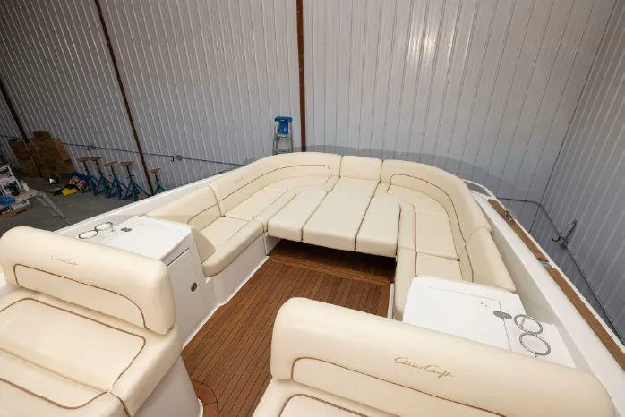 Slide: The Image of 2007 Chris-Craft Corsair 36 boat interior with cream leather seating and wooden flooring. - 6
