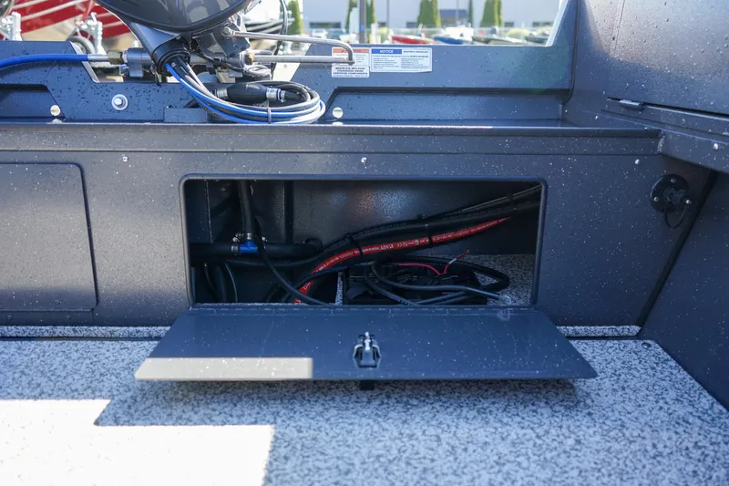 Slide: The Image of 2025 Alumaweld Adventurer 20 boat storage compartment with visible wiring. - 13