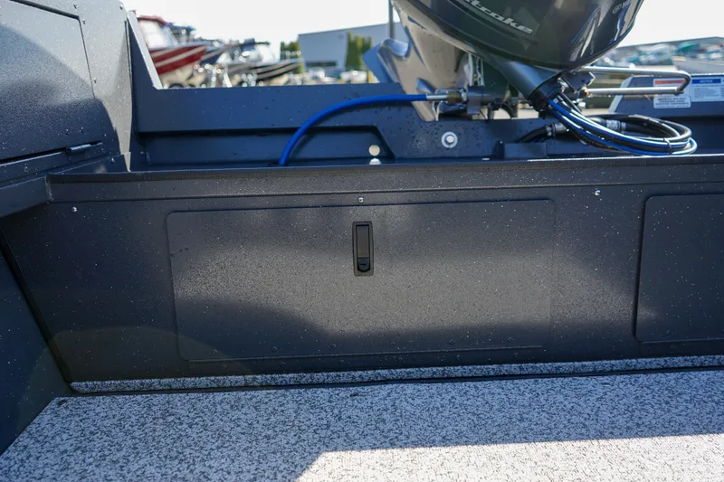 Slide: The Image of 2025 Alumaweld Adventurer 20 boat interior with storage compartment and motor details. - 14