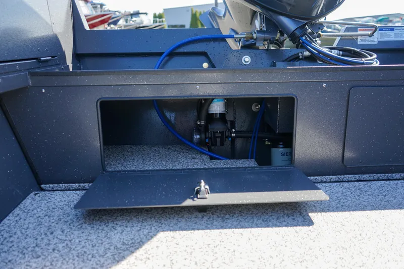 Slide: The Image of 2025 Alumaweld Adventurer 20 boat storage compartment with visible wiring and components. - 15