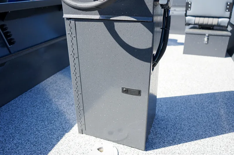 Slide: The Image of 2025 Alumaweld Adventurer 20 boat interior, featuring a sleek control console on a textured floor. - 16