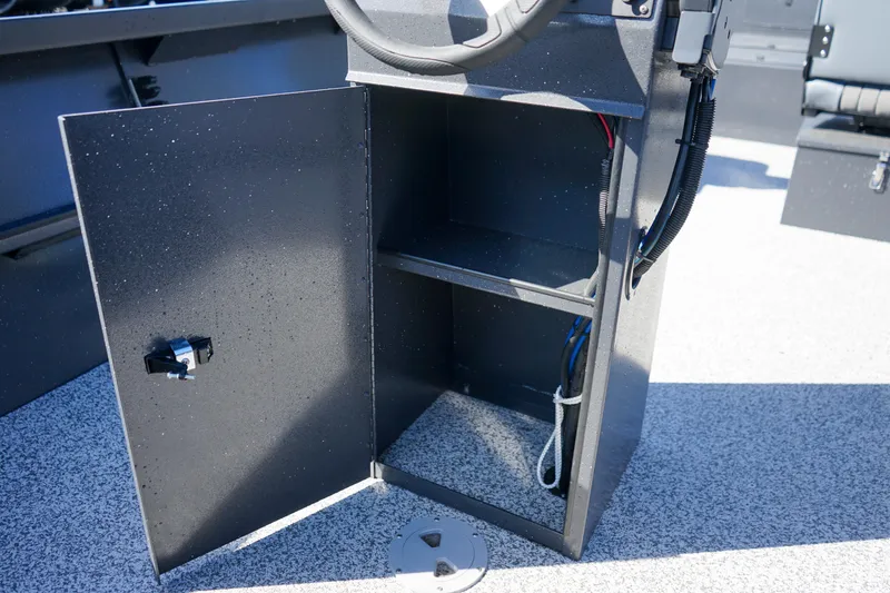 Slide: The Image of Open storage compartment in 2025 Alumaweld Adventurer 20 boat console. - 17