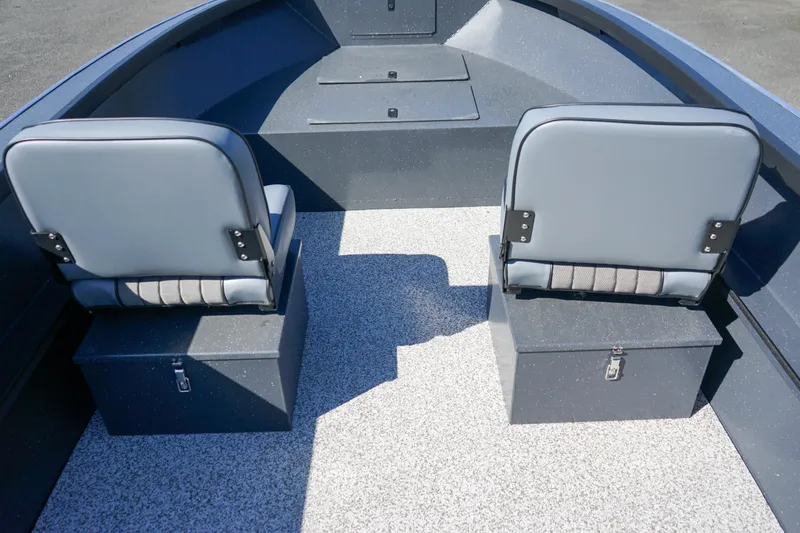 Slide: The Image of 2025 Alumaweld Adventurer 20 boat interior with two gray seats and storage compartments. - 18