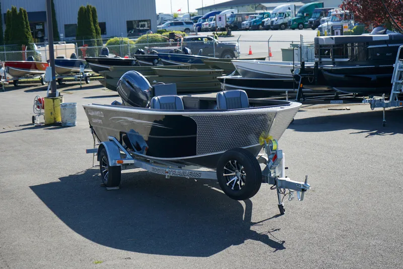 Slide: The Image of 2025 Alumaweld Adventurer 20 boat on trailer in outdoor dealership lot. - 22