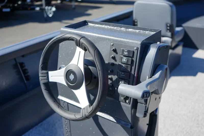 Slide: The Image of 2025 Alumaweld Adventurer 20 boat steering console with controls and steering wheel. - 8