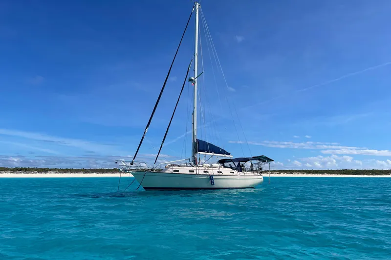 The Image of Sailboat Island Packet 380 (2002) on clear blue water under a sunny sky. - 0