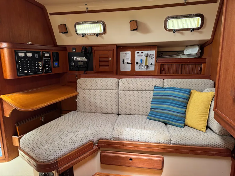 Slide: The Image of Interior of 2002 Island Packet 380 sailboat with cozy seating and control panels. - 22