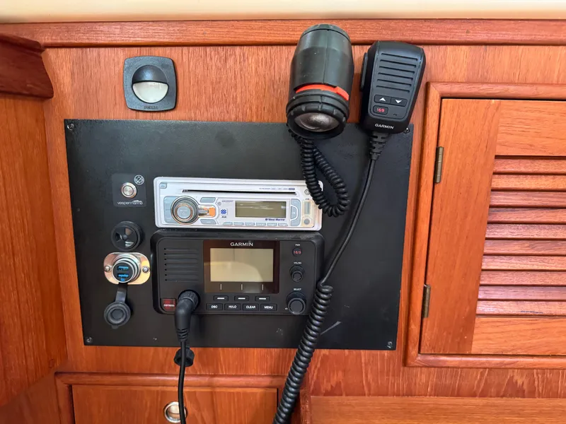 Slide: The Image of Control panel of a 2002 Island Packet 380 sailboat with Garmin and audio equipment. - 24