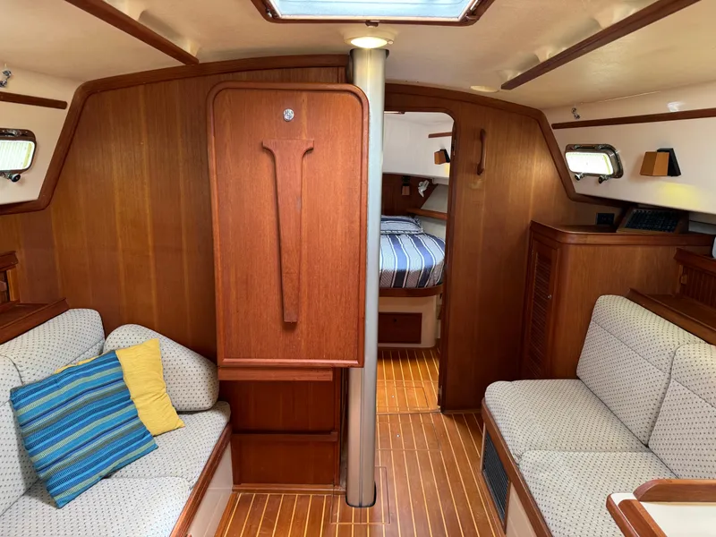 Slide: The Image of Interior of 2002 Island Packet 380 sailboat with cozy seating and wooden finishes. - 30