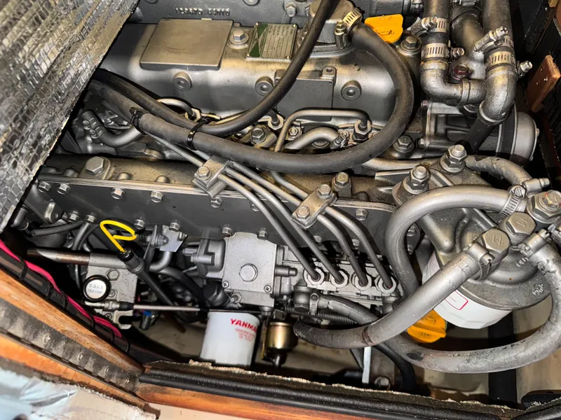 Slide: The Image of Engine compartment of a 2002 Island Packet 380 sailboat, featuring Yanmar components. - 33