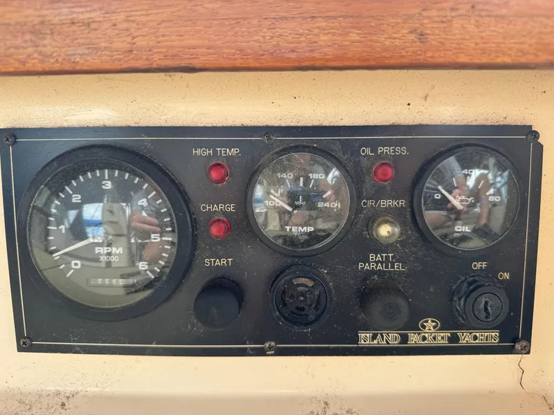 Slide: The Image of Control panel of a 2002 Island Packet 380 yacht with RPM, temperature, and oil pressure gauges. - 35