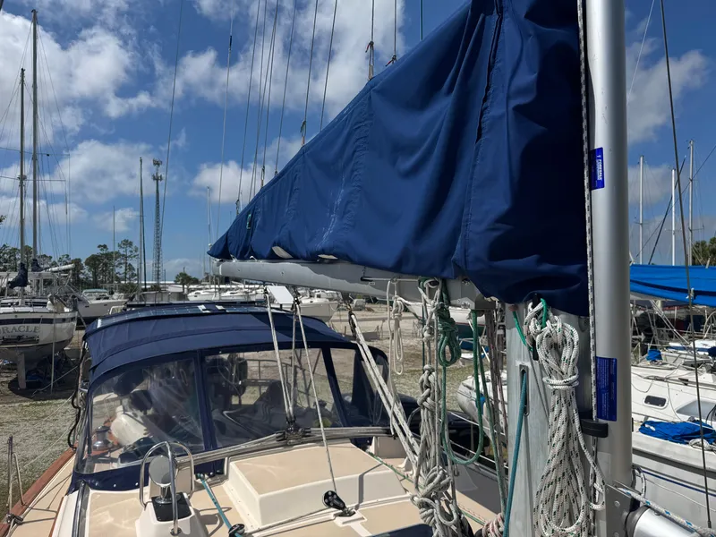 Slide: The Image of Island Packet 380 sailboat, 2002 model, docked with blue sail cover and clear sky. - 4