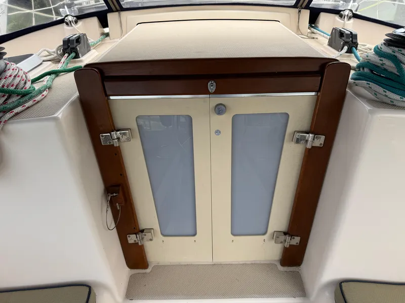 Slide: The Image of Cabin entrance of 2002 Island Packet 380 sailboat with wooden trim and secured ropes. - 41