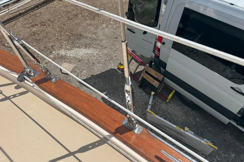 Slide: The Image of Deck view of 2002 Island Packet 380 sailboat with nearby parked van. - 8