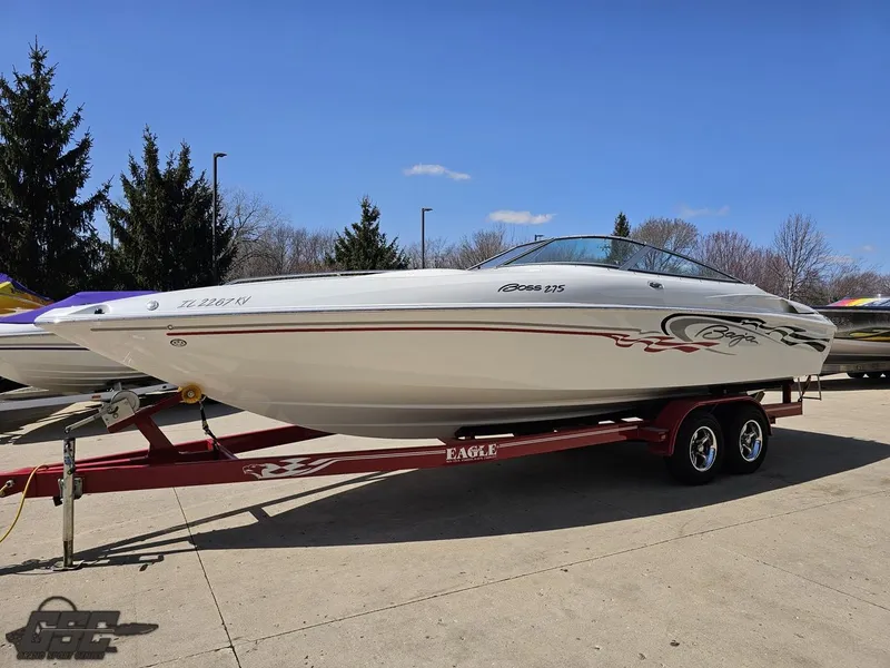 Slide: The Image of 2004 Baja 275 speedboat on trailer, parked outdoors, clear sky background. - 17