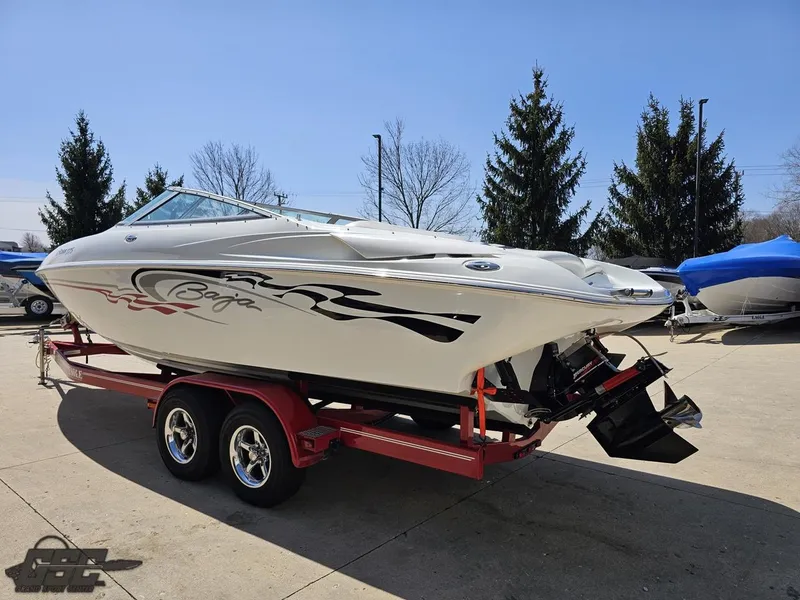 Slide: The Image of 2004 Baja 275 speedboat on a red trailer, parked outdoors under clear skies. - 26