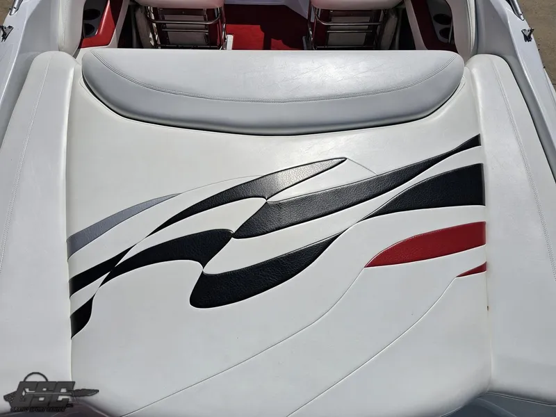 Slide: The Image of 2004 Baja 275 boat interior with stylish white, black, and red upholstery design. - 37