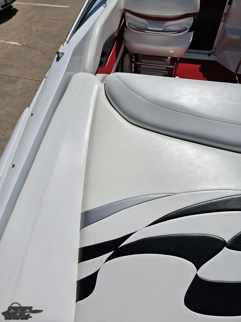 Slide: The Image of 2004 Baja 275 boat interior with white and gray seating, red carpet, and sleek design. - 40