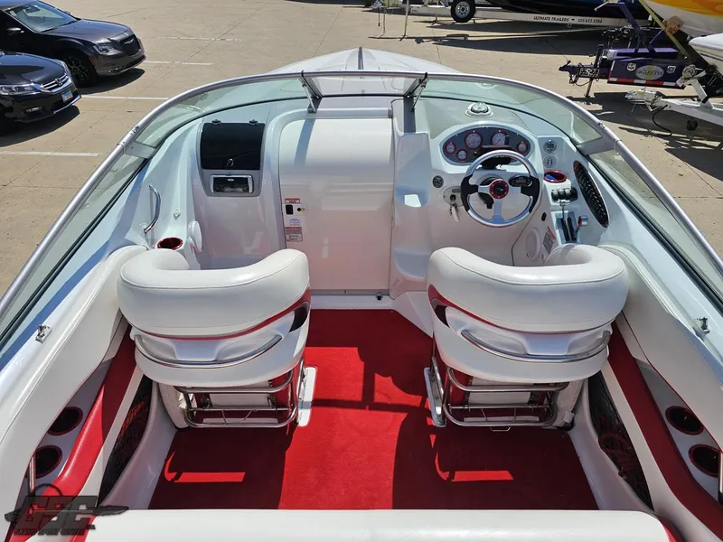 Slide: The Image of Interior of a 2004 Baja 275 boat with white seats and red carpet. - 43