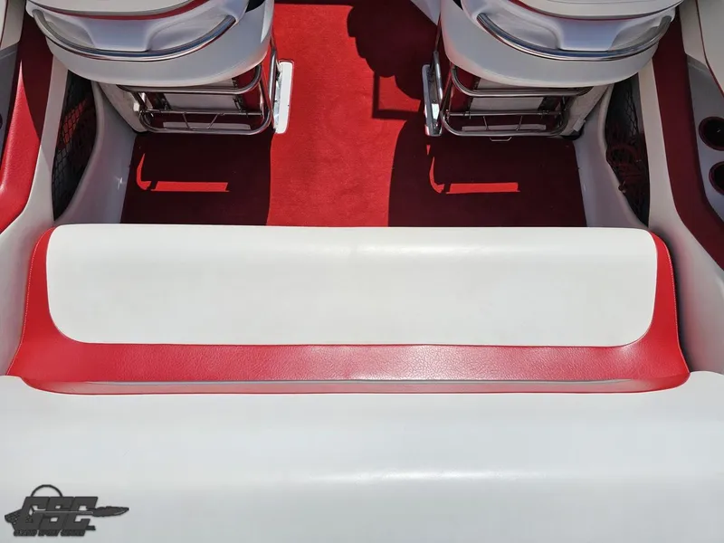 Slide: The Image of 2004 Baja 275 boat interior with red and white seating and carpet. - 44