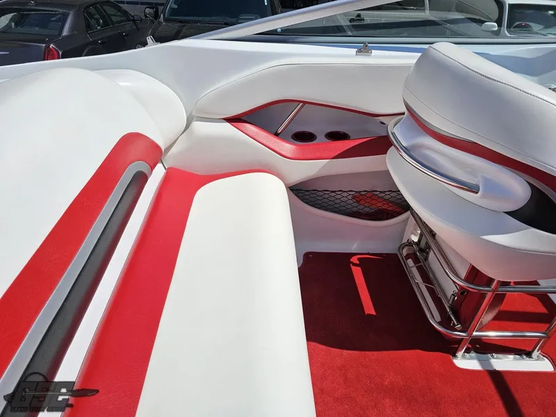 Slide: The Image of 2004 Baja 275 boat interior with red and white seating, cup holders, and storage net. - 46