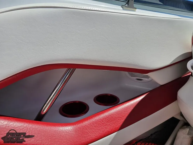 Slide: The Image of 2004 Baja 275 boat interior with red and white upholstery and cup holders. - 48