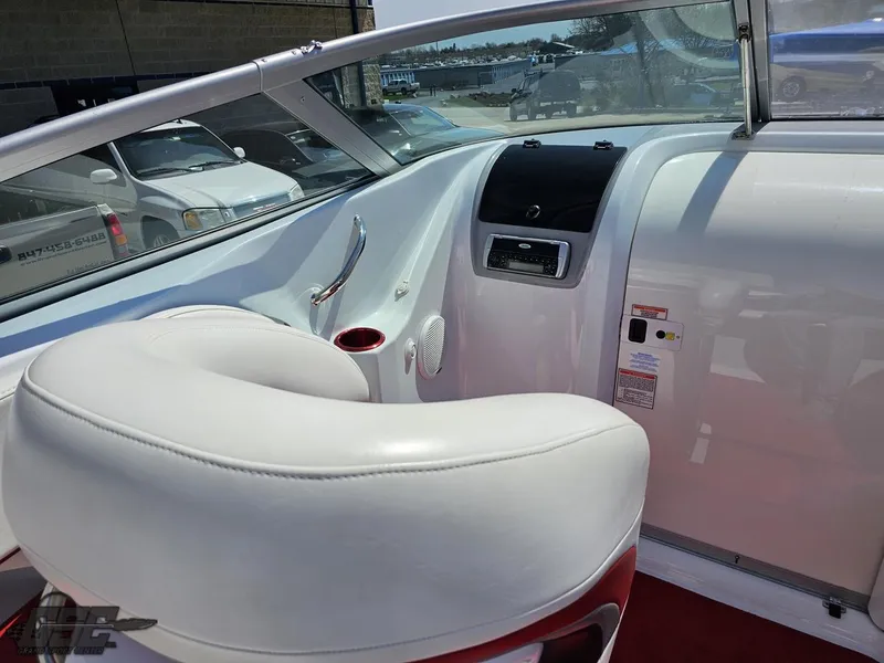 Slide: The Image of Interior view of a 2004 Baja 275 boat, featuring white seating and dashboard. - 49