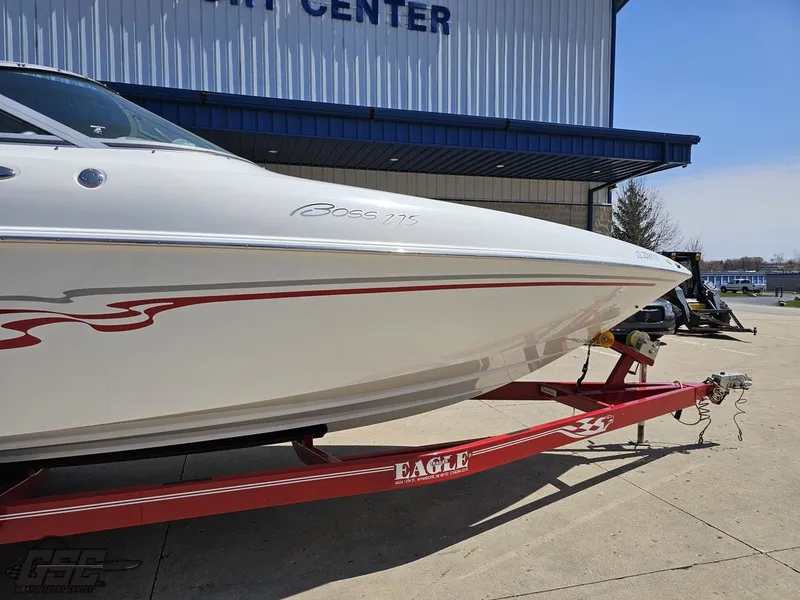 Slide: The Image of 2004 Baja 275 boat on red Eagle trailer outside a marine center. - 7