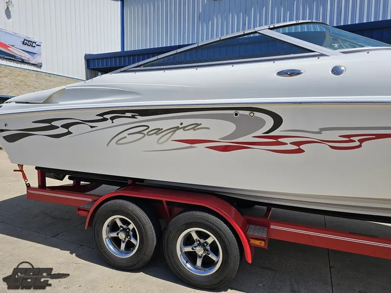 Slide: The Image of 2004 Baja 275 boat on red trailer, featuring sleek graphics and modern design. - 9
