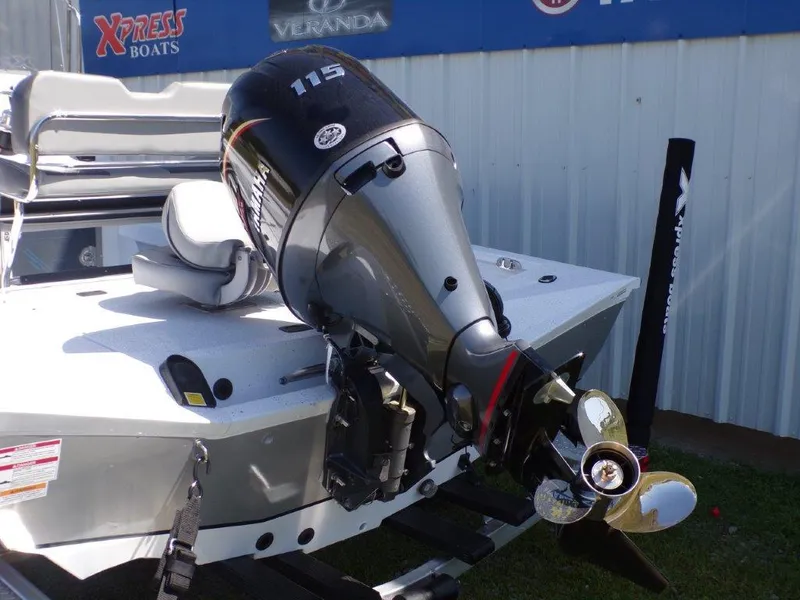 Slide: The Image of 2025 Xpress H20BAY boat with Yamaha 115 outboard motor, displayed outdoors. - 1