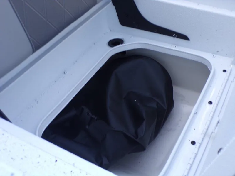 Slide: The Image of 2025 Xpress H20BAY boat storage compartment with black cover inside. - 21