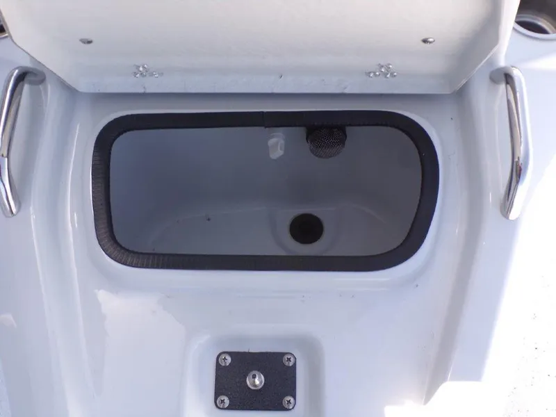 Slide: The Image of Open storage compartment on 2025 Xpress H20BAY boat, featuring stainless steel handles. - 8