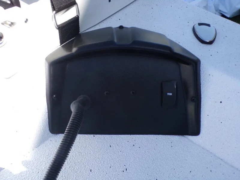 Slide: The Image of 2025 Xpress H20BAY boat dashboard with trim control and cable connection. - 9