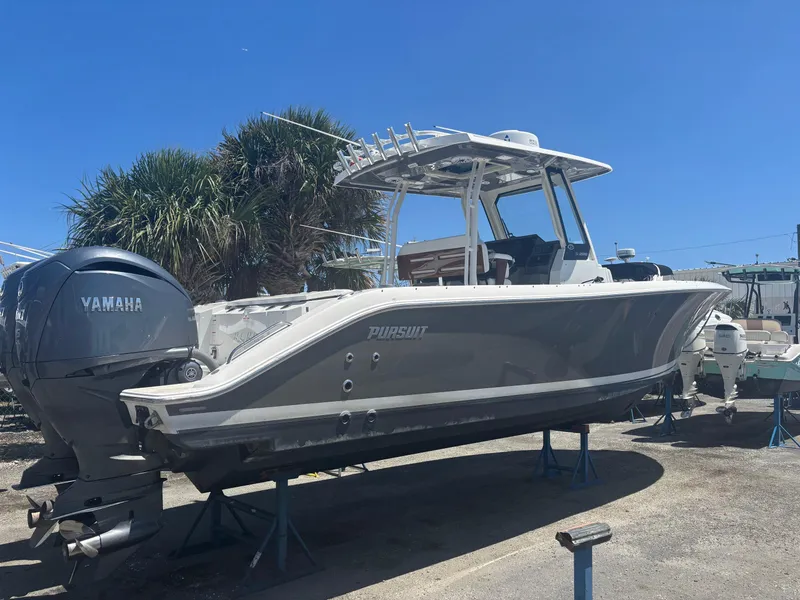 Slide: The Image of 2022 Pursuit S 288 boat with Yamaha engines on display outdoors. - 28