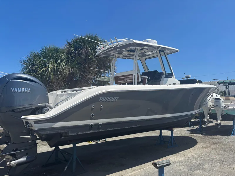 Slide: The Image of 2022 Pursuit S 288 boat with Yamaha engine, displayed outdoors on a sunny day. - 29