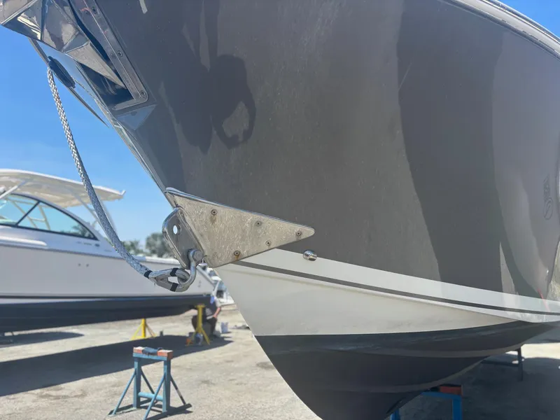 Slide: The Image of 2022 Pursuit S 288 boat bow on display in a marina setting. - 31