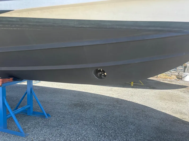 Slide: The Image of 2022 Pursuit S 288 boat hull on stand, showcasing sleek design and craftsmanship. - 33